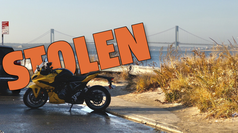Amber's motorcycle parked on Coney Island with the word STOLEN behind it