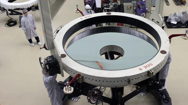 Crane operators lower the support equipment to move the Roman Space Telescope's primary mirror