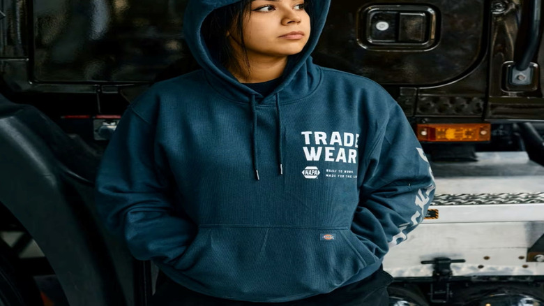 A student wears a TradeWear hoodie