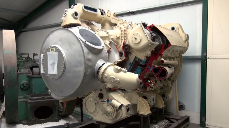A front angled view of a white cutaway Napier Deltic 18-cylinder diesel engine on a stand at the Anson Engine Museum in Poynton, England