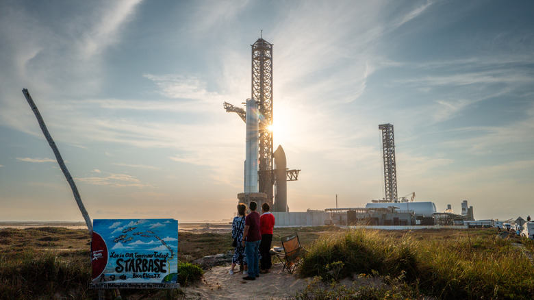 People watch SpaceX Starship Flight 8 as it is stationed near Orbital Launch Pad A ahead of launch at Boca Chica beach on March 03, 2025 in Boca Chica Beach, Texas.