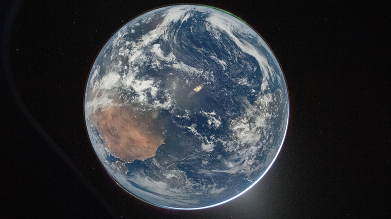 NASA astronaut and Artemis II Commander Reid Wiseman took this picture of Earth from the Orion spacecraft's window on April 2, 2026, after completing the translunar injection burn.