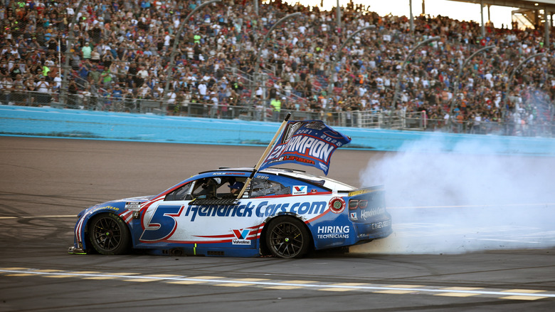 Kyle Larson, driver of the #5 HendrickCars.com Chevrolet, celebrates with a burnout after finishing first of the NASCAR Cup Series Championship 4 drivers to win the NASCAR Cup Series Championship at Phoenix Raceway on November 02, 2025 in Avondale, Arizona.