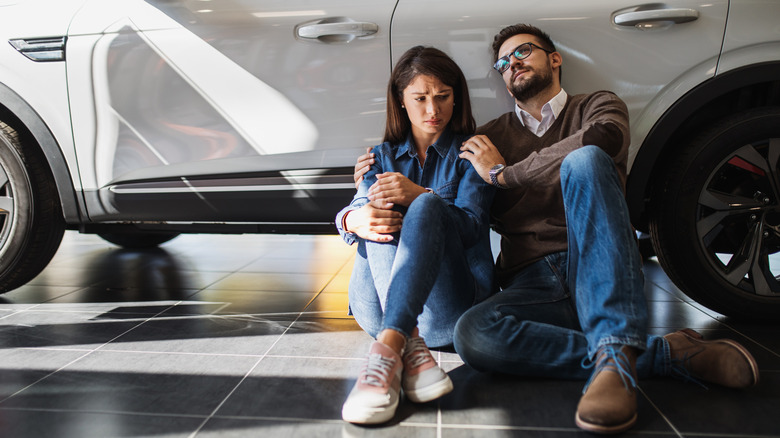 two sad car buyers