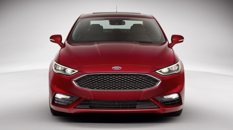 front of a red Ford Fusion