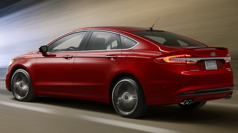 rear 3/4 of a red Ford Fusion