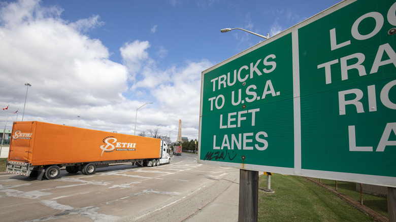 Trucks make their way to the Ambassador Bridge to cross into the United States at Detroit on April 1, 2025 in Windsor, Canada.