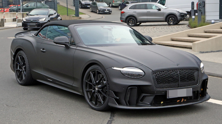 Front 3/4 view of a matte black Bentley Supersports convertible