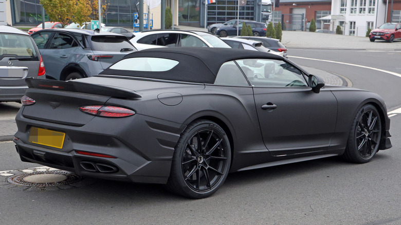 Rear 3/4 view of a matte black Bentley Supersports convertible prototype