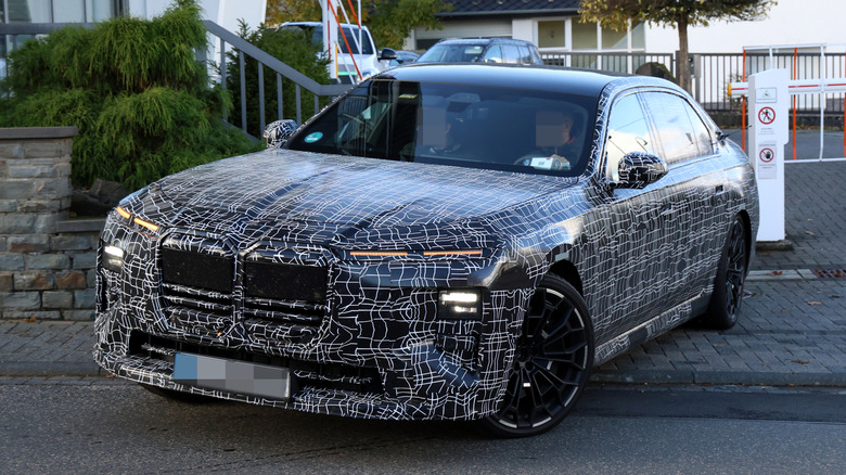 Front 3/4 view of a camouflaged BMW Alpina B7 prototype