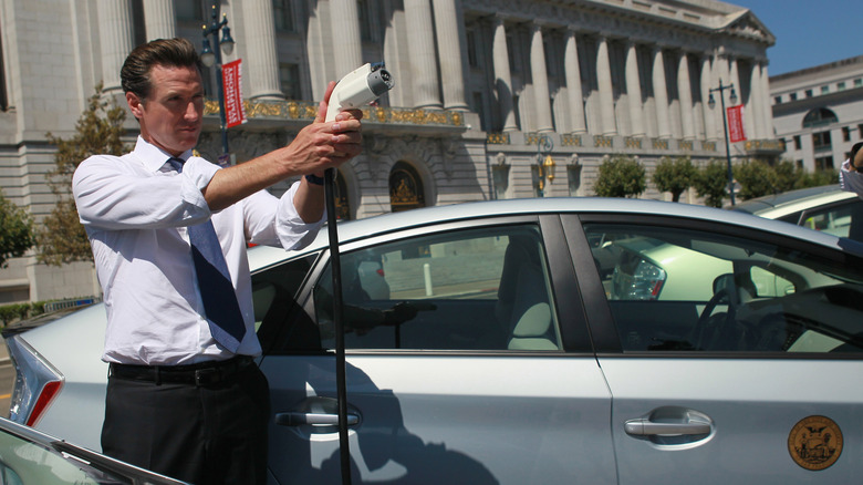 SAN FRANCISCO - AUGUST 25: San Francisco mayor Gavin Newsom holds a power cable before test driving a plug-in version of the popular Toyota Prius that is one of four on loan to the city for evaluation August 25, 2010 in San Francisco, California. With sales of electric and plug-in hybrid cars expected to increase in the coming years, the Bay Area Air Quality Management District has set aside $5 million to increase the number of electric car charging stations to 5,000 around the Bay Area. There are currently 120 stations in the area. (Photo by Justin Sullivan/Getty Images)