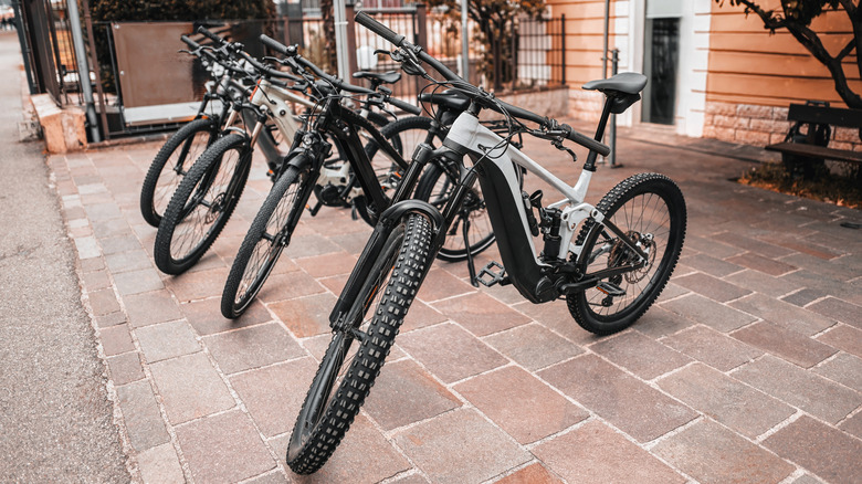 Four e-bikes parked outside a shop in the city