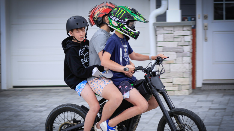 Three children riding an e-bike in New Jersey