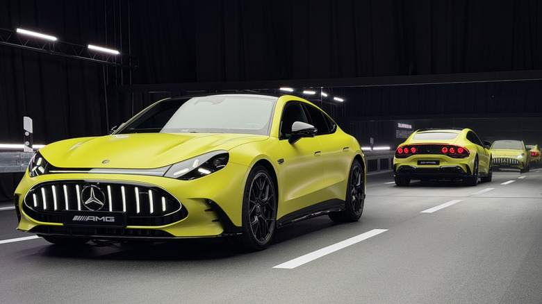 A front three-quarters shot of a highlighter yellow AMG GT 4-Door parked in a studio that looks like it's driving on a road, in front of mirrors that show reflections of its rear and front