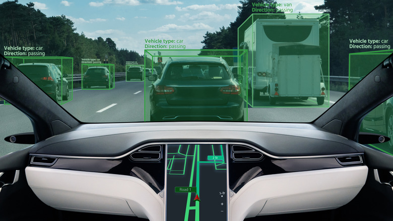 The dashboard of an autonomous vehicle shows a tablet with a route, outside the windshield the vehicles are highlighted with directions and vehicle types.