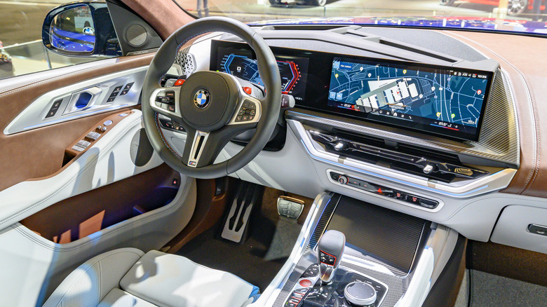BMW interior with large screens showing onboard navigation