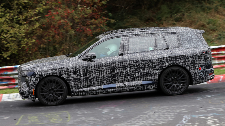 Side view of a camouflaged BMW X7 M60 prototype