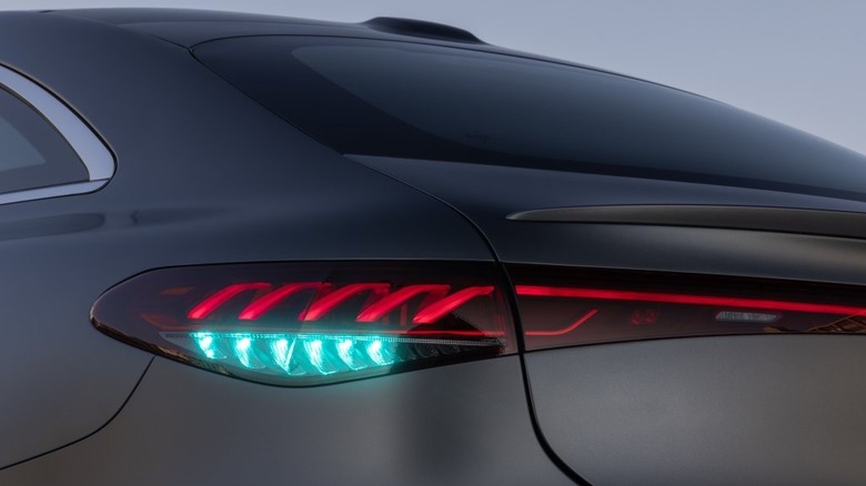 Close-up of the cyan rear lights on the matte gray Mercedes-Benz EQS