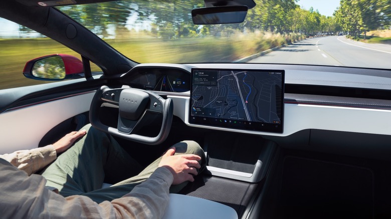 Inside view of a Tesla Model S on the highway in Full Self-Driving (Supervised) mode