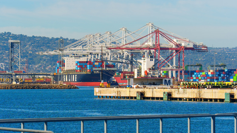 Long Beach, California - January 7, 2026: Large container ship docked at the Port of Long Beach with gantry cranes loading cargo under a clear blue sky during the daytime.