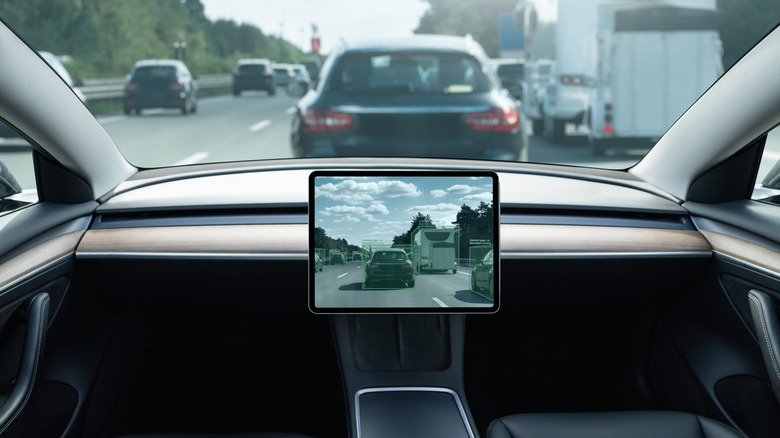 A self-driving car on the road without a steering wheel and controls.