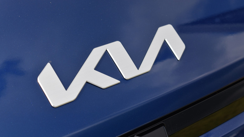 Beesd, the Netherlands - September 12, 2025: close up shot, the Kia badge of a blue 2025 Kia EV4