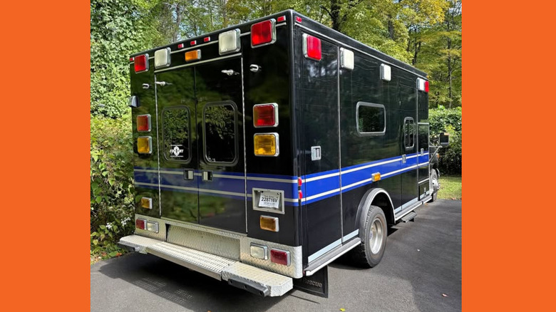 A black and blue ambulance from the rear