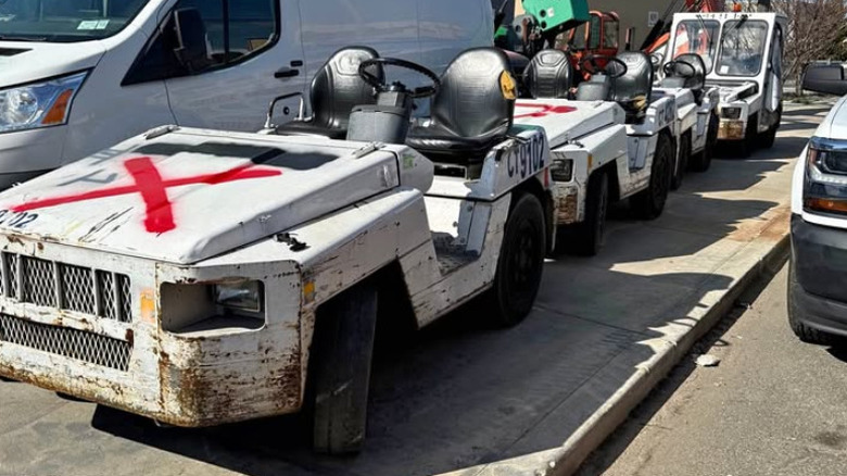 Four Toyota tow vehicles in various states of disrepair