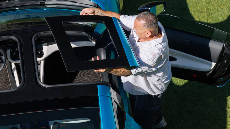 A man taking off a T-top on the Nissan Z Kaze concept