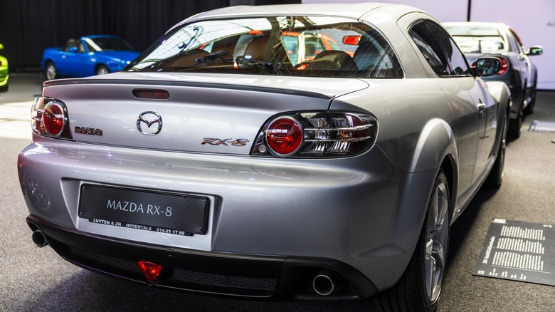 The rear end of a silver Mazda RX-8 in a car museum