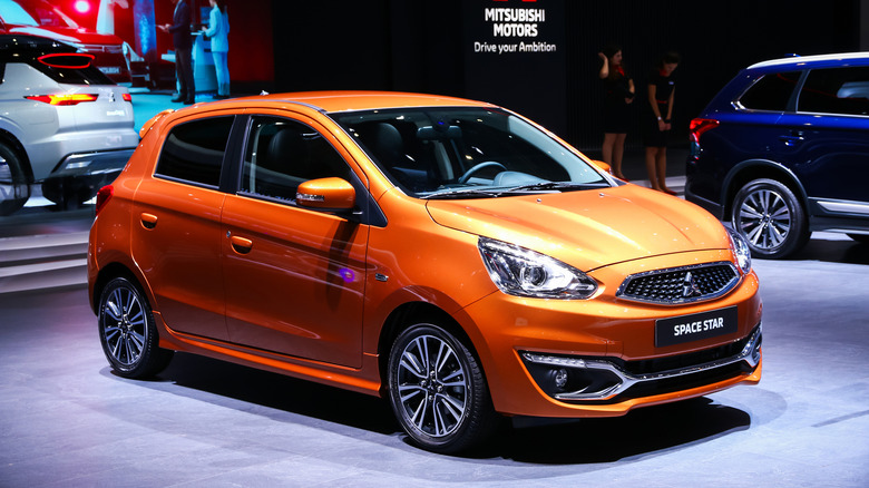 An orange 2019 Mitsubishi Mirage at an auto show