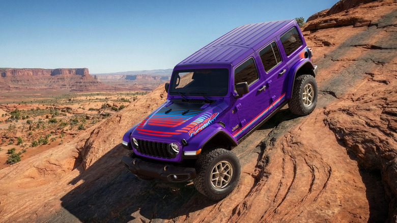 A purple Jeep Wrangler with graphics and bronze wheels