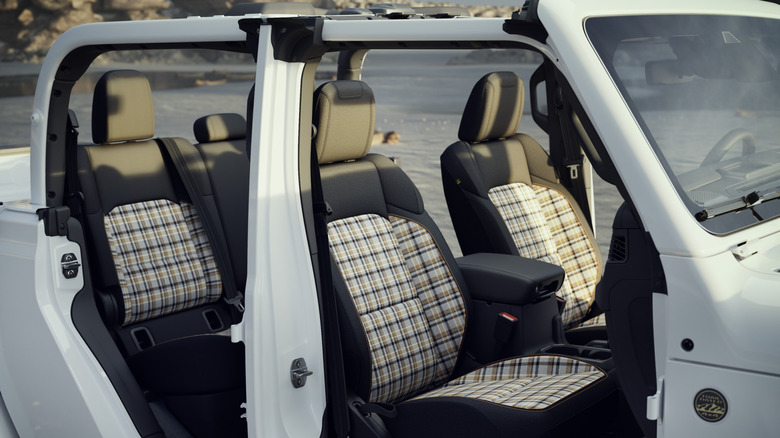 A look at the plaid interior of the 85th Anniversary edition on a white Wrangler with its doors and roof off