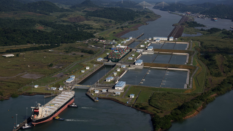 In an aerial view, the container ship Tampa Triumph passes through the Miraflores Locks as it transits the Panama Canal on September 20, 2023 in Panama City, Panama.
