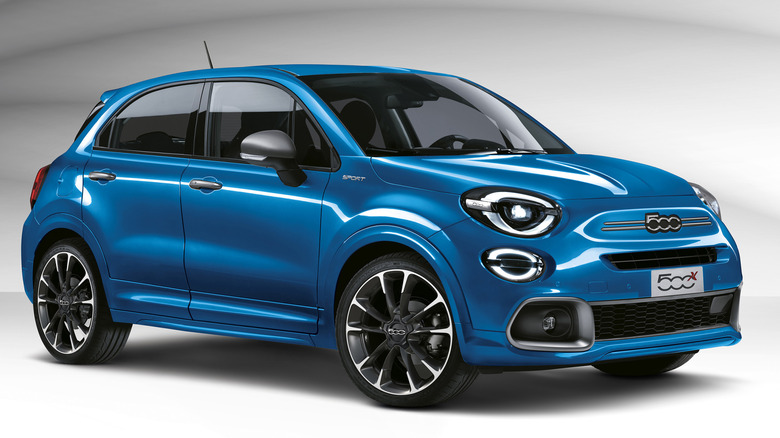 A front three quarters shot of a blue Fiat 500X shot in front of a white background