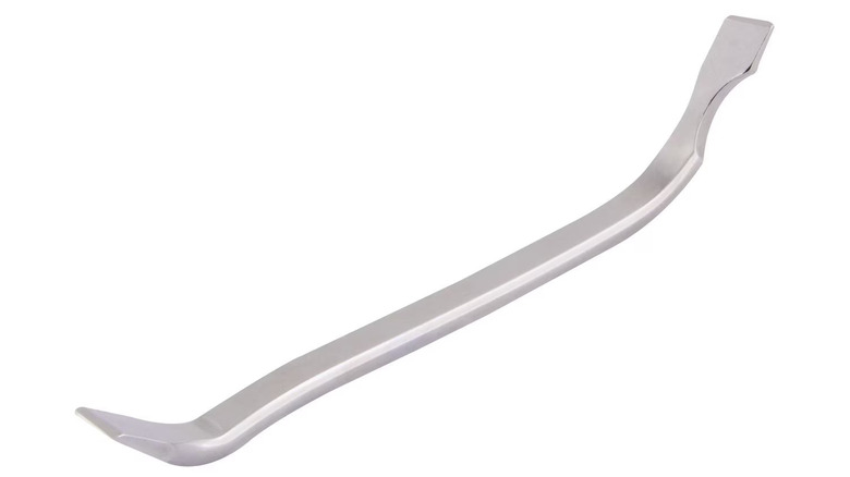 A close-up product image of a silver metal Duralast brake spoon against a white background.