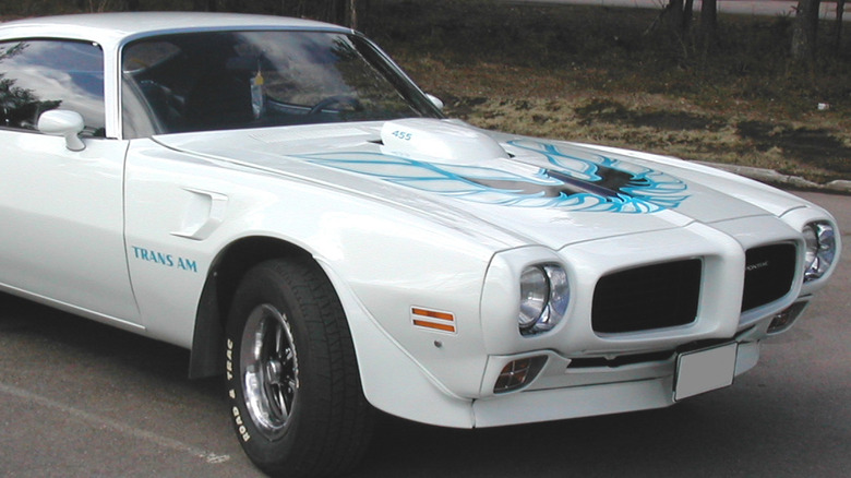 A white 1973 Pontiac Trans-Am car parked outside