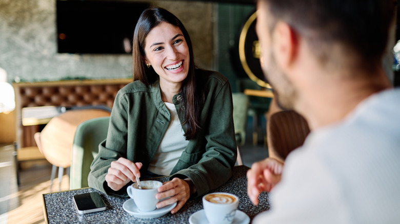 man and woman drinking coffee in a coffee shop