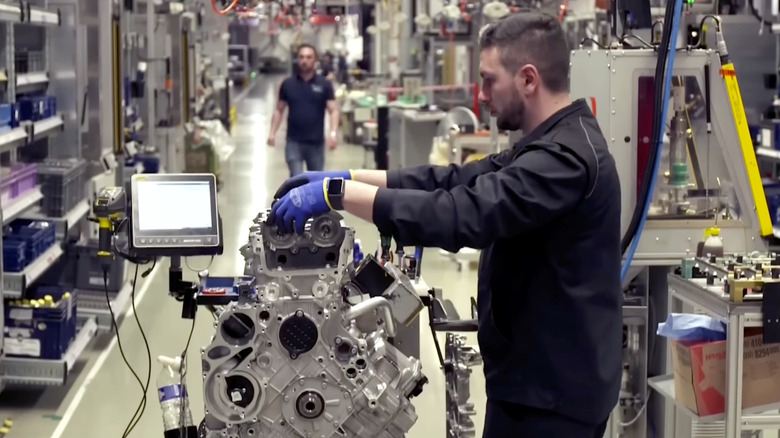 An AMG engine builder assembling an M177 V8 engine in the company's Affalterbach facility.