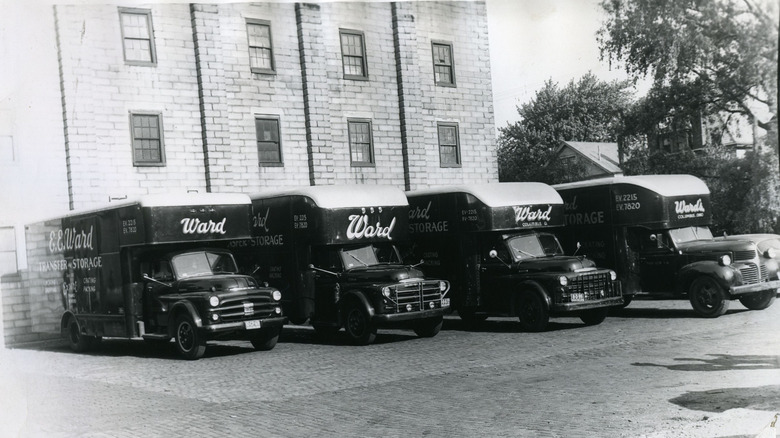 A black-and-white photo of a row of E.E. Ward moving trucks dating to the 1950s