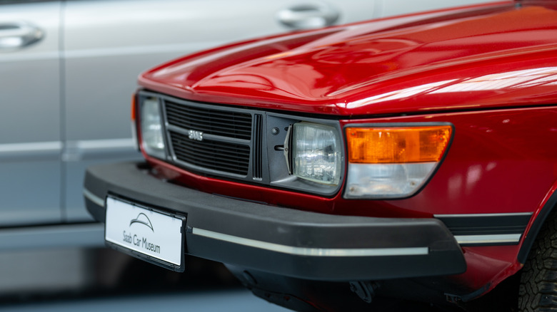 The front end of a red Saab 99 sitting in the Saab Car museum