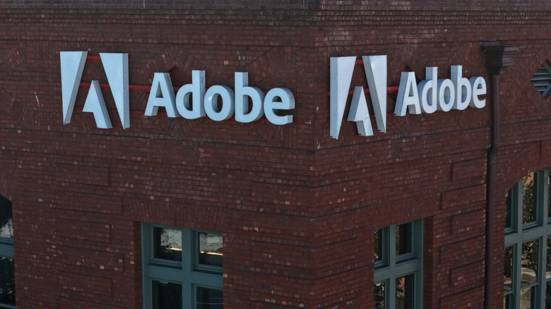 In an aerial view, a sign is posted on the exterior of an Adobe office on December 10, 2025 in San Francisco, California.