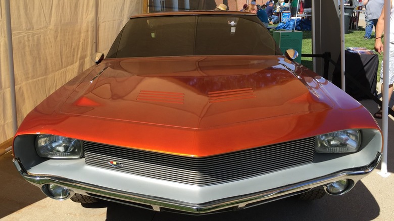 A red-orange 1966 AMC AMX prototype with a Rumble Seat