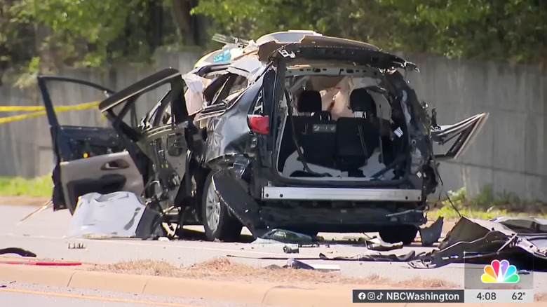 Screenshot from the news broadcast showing the rear view of the black Pacifica after the explosion, with all doors blown out and parts strewn around