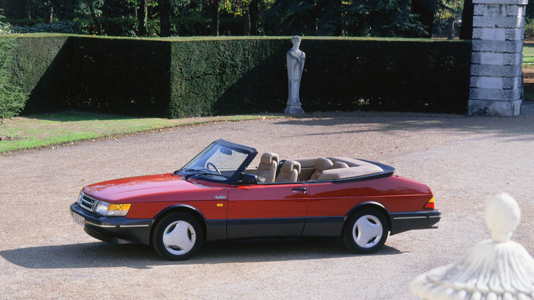 A red Saab 900 convertible in a courtyard