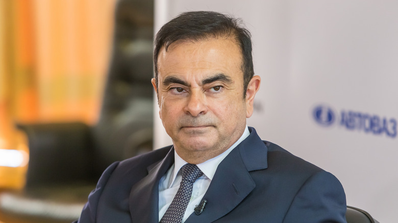 Carlos Ghosn wearing a suit and looking to his left