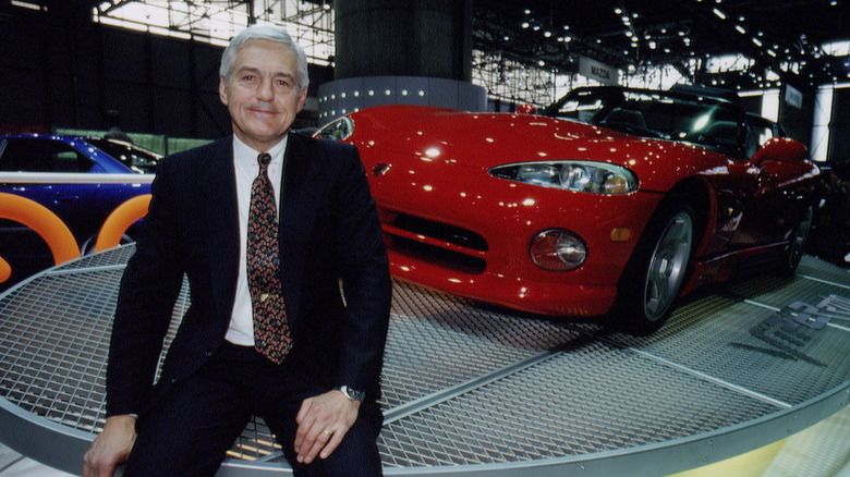 Bob Lutz sitting on a platform in front of a Dodge Viper