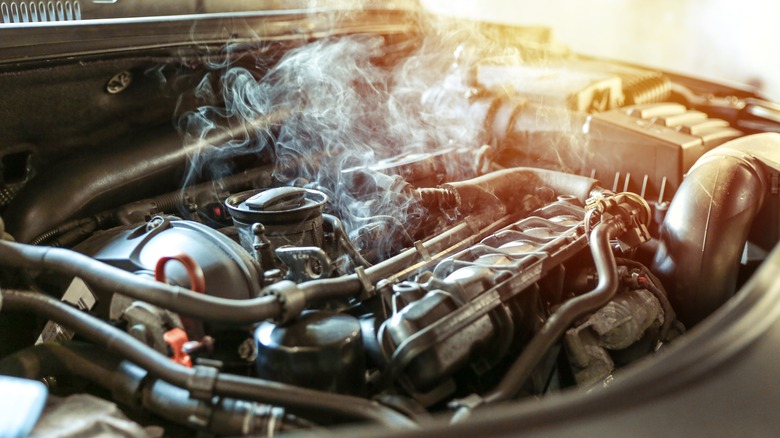 Smoke coming from a car's engine.