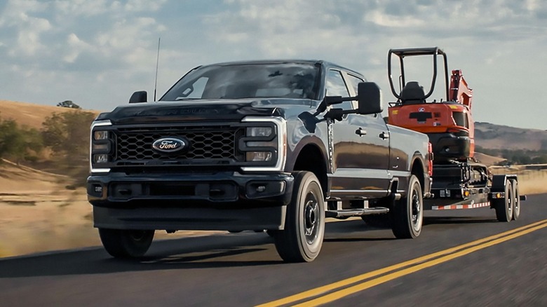 A Ford Super Duty dually towing construction equipment