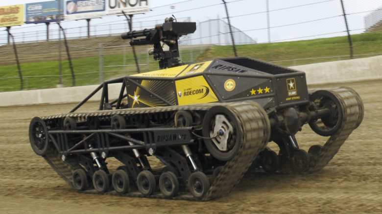 The U.S. Army Research, Development and Engineering Command demonstrates a minigun-equipped Howe & Howe Ripsaw at the Eldora Speedway Racing Event dirt track